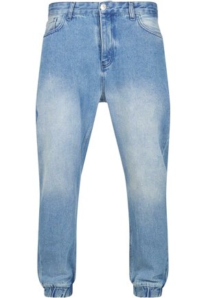 Heledan sinised denim jogger-püksid elastse vöökoha ja mansettidega, millel on pleekinud pesu ja traditsiooniline viietasku disain.