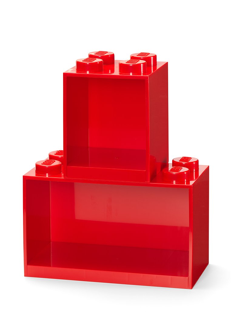 Bloques de almacenamiento de plástico rojo con un acabado brillante. Un bloque más grande sostiene a un bloque más pequeño. Ambos tienen la parte superior redondeada con forma de pernos.