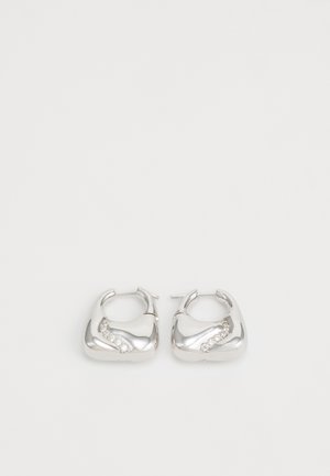 Silver hoop earrings with a smooth, rounded design and a wavy accent featuring small, clear rhinestones along one edge.