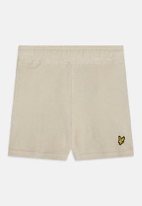 Beige Shorts aus weichem Stoff mit einem elastischen Bund, ausgestattet mit einem kleinen schwarzen und gelben Schmetterlingslogo auf der unteren linken Seite.