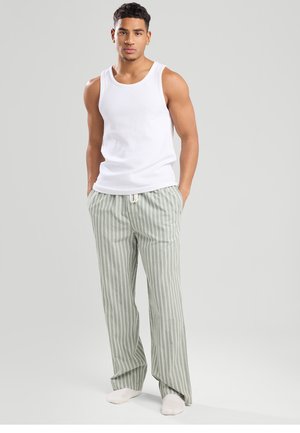 White sleeveless tank top and light green striped pants with drawstring waist, featuring a relaxed fit and soft fabric texture.