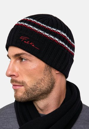 Knitted black beanie featuring red, white, and blue stripes. Embroidered brand name in red. Textured, stretch fit, and warm design.