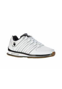 White athletic shoes with a smooth leather upper, black accents, six lace eyelets, and a rubber sole featuring a slight heel.