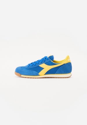 Blue and yellow athletic shoe with a suede and mesh upper, round toe, rubber sole, and textured accents along the sides.