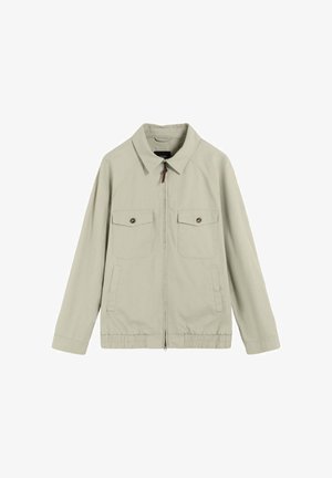Veste beige zippée à manches longues, avec deux poches à rabat boutonnées sur le devant, deux poches fendues sur les côtés, ourlet élastique et col classique.