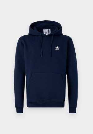 Navy blue hoodie made of soft, textured fabric. Features a front pocket, drawstring hood, and white logo on the chest. Simple design.