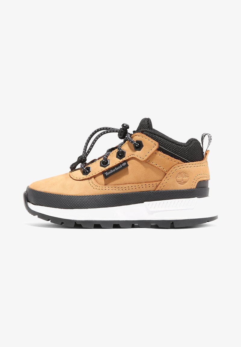 Tan suede and black textile sneaker with a thick white midsole, round laces, and black rubber outsole. Features a brand logo tag on the side.