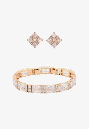 Gold-toned bracelet and matching stud earrings with large rectangular and square clear gemstones in a geometric pattern.
