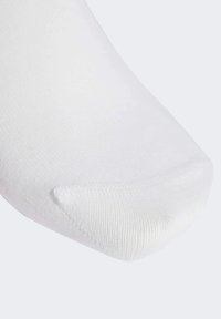 White cotton sock with a smooth texture and reinforced toe. Features a standard athletic shape and subtle ribbed pattern.