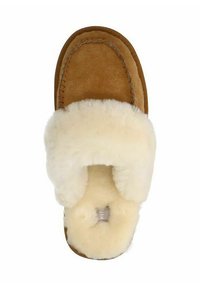 Brown suede slipper with a white faux fur strap, rounded shape, stitched edges, and a soft interior. Designed for comfort and warmth.