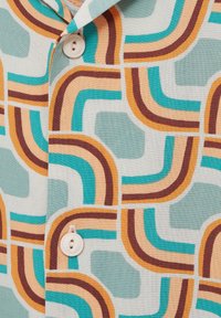 Button-up shirt in lightweight fabric featuring abstract, multicolored geometric patterns in turquoise, brown, orange, and cream.