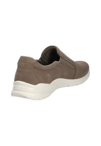 Brauner Slipper mit einem Obermaterial aus Wildleder, durchbrochenen Details, elastischen Seiteneinsätzen und einer weißen Gummisohle.