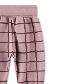 Weiche rosa Leggings mit einem breiten Bund und einem Rautenmuster in Dunkelbraun. Der Stoff scheint dehnbar und bequem zu sein, geeignet für legere Anlässe.