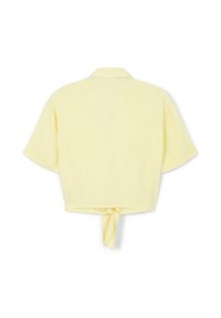 Blusa corta a maniche corte in morbido tessuto giallo, con colletto e nodo legato sul retro per la regolazione.