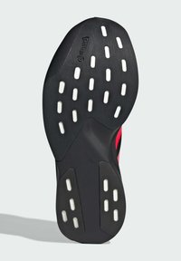 Suola di scarpa in gomma nera con fori circolari e ovali bianchi. Presenta una superficie testurizzata e il logo "Continental" vicino al tallone.