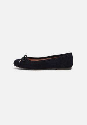 Schwarzer Ballettschuh mit niedrigem Absatz, rundem Zeh und kleinem dekorativen Schleifchen vorne, von der Seite auf einfachem Hintergrund gezeigt.