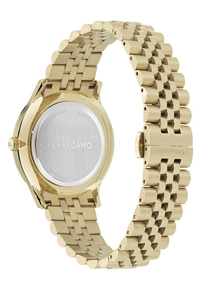 Arany színű rozsdamentes acél karóra láncszemes szíjazással. Kerek tokozással, sima lünettával és márkanévvel gravírozott masszív hátlappal.