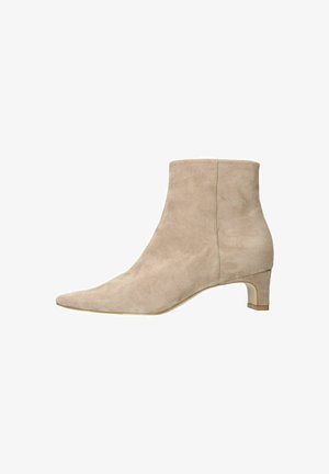 Beige suede ankle boots with a pointed toe and a low block heel, featuring a smooth texture and minimal seam detailing.