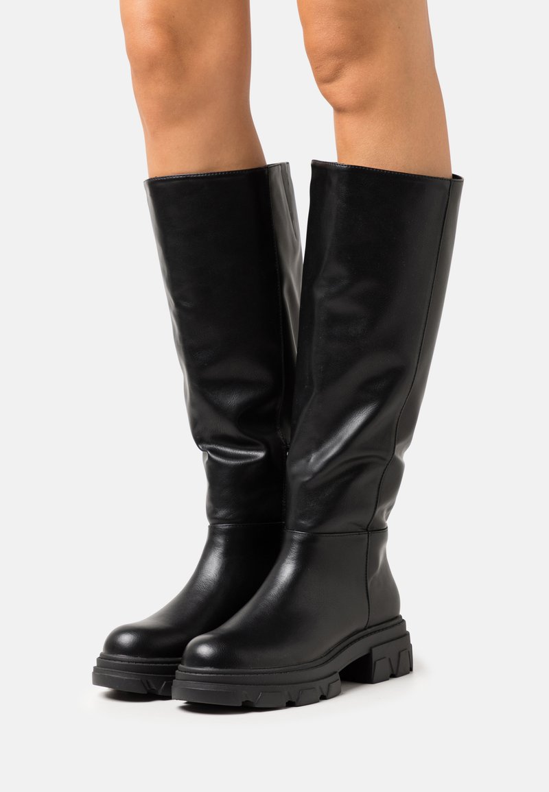 Knee-high black leather boots with a smooth finish, chunky sole, and textured heel. Features a rounded toe and minimal stitching.
