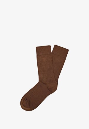 Calze marroni a costine realizzate in morbido tessuto, con un design a metà polpaccio, di un colore uniforme e una superficie liscia.