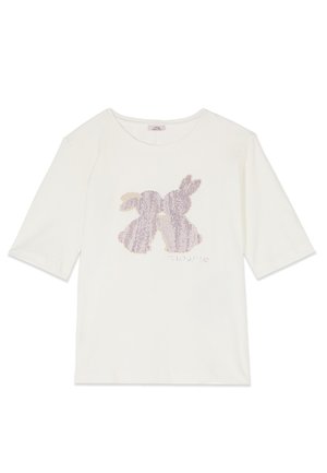 Witte shirt met lange mouwen met twee tegenovergestelde konijnensilhouetten van pailletten in lichtroze en beige op de borst.