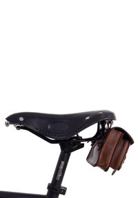 Black leather bicycle saddle with attached small brown leather bag hanging underneath, mounted on a black Ergotec seat post.