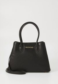 Black leather handbag with a structured shape, two top handles, a removable shoulder strap, and gold branding on the front. Smooth texture.