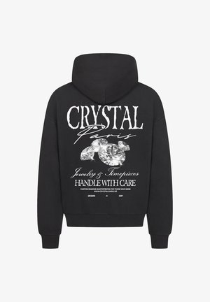 Black hoodie featuring a large graphic print of sparkling diamonds and text "CRYSTAL Paris Jewelry & Timepieces" on the back.