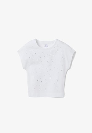 T-shirt blanc à manches courtes pour enfants, orné de petits clous argentés espacés uniformément sur le devant, avec un col rond.