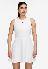 Bijela haljina bez rukava s okruglim izrezom i raširenom suknjom. Nike logo u crnoj boji na prsima, izrađena od glatkog, laganog materijala.