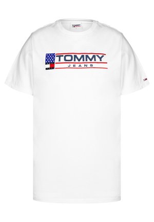 Camiseta de algodón blanca con un logo "TOMMY JEANS" en azul y rojo, gráfico de bandera estadounidense, mangas cortas y cuello redondo.