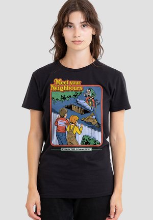 Young woman wears black T-shirt featuring cartoon with children watching a grave being dug and text "Meet your Neighbours" and "Fun in the community."