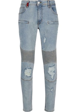 Lichtblauwe denim jeans met versleten details, streepaccenten op de knieën, vijf zakken en een knoopsluiting. Strak design met naden.
