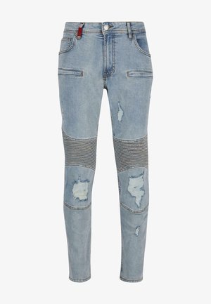 Lichtblauwe denim jeans met versleten details, streepaccenten op de knieën, vijf zakken en een knoopsluiting. Strak design met naden.