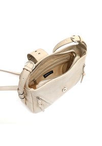 Beige crossbody bag made of textured material with a zip closure, interior pockets, and adjustable strap with buckle details.