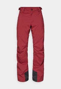 Pantalons d'extérieur isolés et rouges avec poches zippées, onglets de taille ajustables, renfort en tissu noir au niveau des poignets, conçus pour les temps froids.