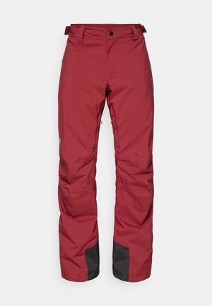 Pantalons d'extérieur isolés et rouges avec poches zippées, onglets de taille ajustables, renfort en tissu noir au niveau des poignets, conçus pour les temps froids.