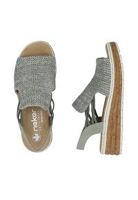 Sandales grises tissées à bout ouvert avec semelles compensées en liège, brides latérales élastiques et semelles intérieures rembourrées portant l'inscription "Rieker Antistress Extra Wide".