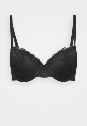 Soutien-gorge en dentelle noire avec coques rembourrées et bretelles réglables, présentant un bord festonné et un motif floral sur les coques et les côtés.