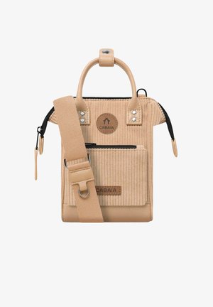 Beige corduroy bag with a textured surface, featuring two short handles, a removable strap, and a zipper pocket. Logo patch on the front.