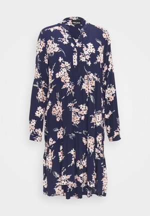 Marineblå kjole med lange ærmer med lyserødt og hvidt blomsterprint, V-udskæring og løs, flydende pasform.