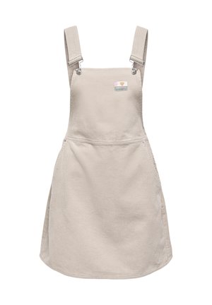 Beiges Cordkleid aus Cordstoff mit verstellbaren Schulterriemen und einem kleinen bunten Aufnäher im Brustbereich.