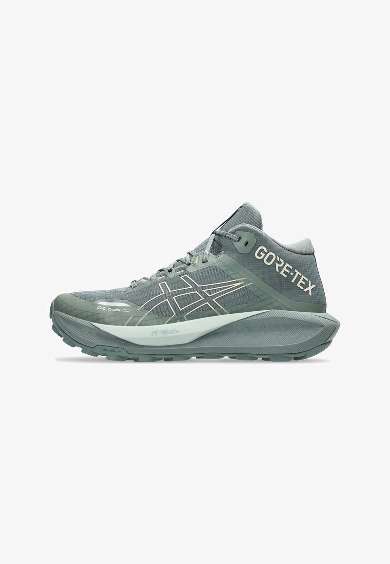 GORE-TEX trail running shoe in light gray with textured upper, reflective accents, padded collar, and durable rubber sole for traction.