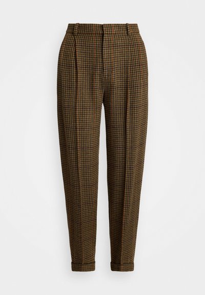 Pruunide ruuduliste pükste pleedid, kitsenevad säärted ja ääred. Valmistatud tekstuursest kangast. Omab peeneid punaseid ja rohelisi aktsente.