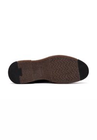 Semelle de chaussure en caoutchouc marron avec un motif texturé en zigzag, accent au talon noir et une section lisse noire sur le bout. Design plat, matériau durable.