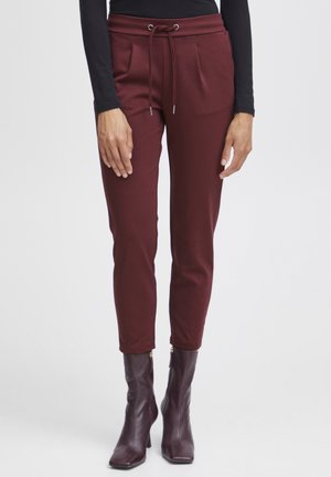 Burgundy jogger pants in a soft material, featuring a drawstring waistband, side pockets, and tapered leg design. Suitable for casual wear.