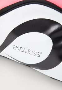 White bag with black wave design and "ENDLESS" logo. Features a textured surface, pink accents, and a smooth black zipper.