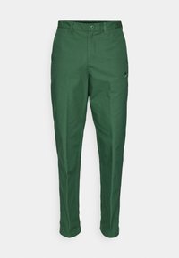 Green cotton pants with a straight fit. Features a button closure and zip fly. Includes a subtle logo on the upper thigh.