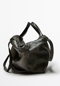 Black leather handbag with a slouchy design, featuring two straps and a zip closure. The texture appears smooth and supple.