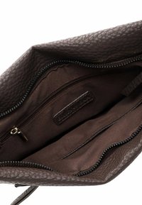 Brown textured leather handbag with a zipper opening, featuring a brown fabric interior, one zippered pocket, and multiple compartments.